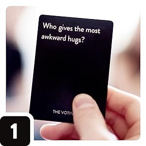 Hand holding up a card that says, "Who gives the most awkward hugs?"