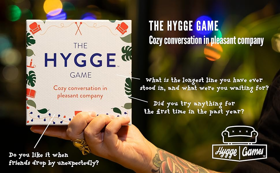 Girl holding family friendly card game, couples game, conversation starter, the hygge game, hygge
