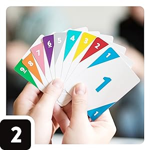 Hands holding an array of differently colored cards numbered 1 to 9.